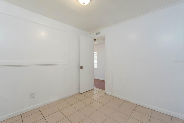 empty room featuring light tile patterned floors