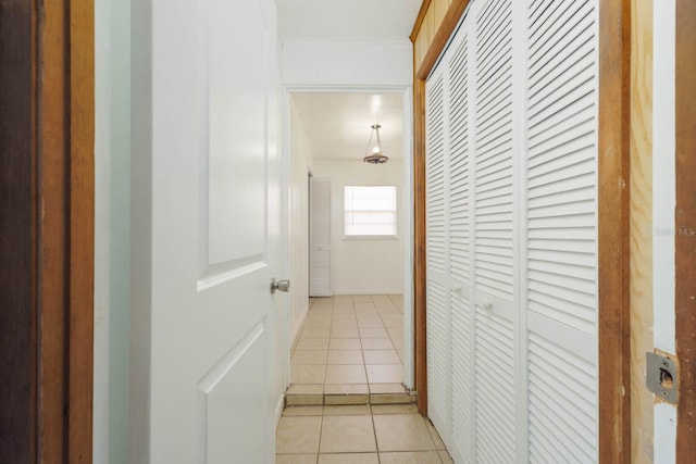 hall with light tile patterned floors