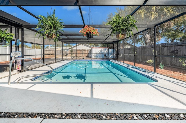 view of pool featuring a patio and glass enclosure