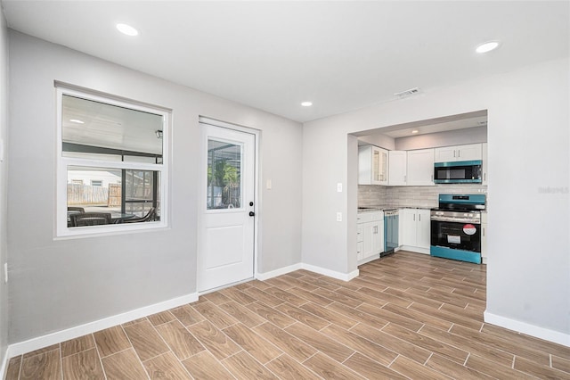 kitchen featuring white cabinetry, tasteful backsplash, and appliances with stainless steel finishes