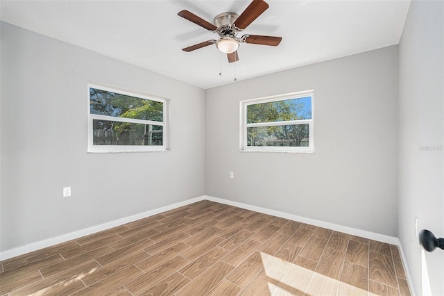 spare room with a healthy amount of sunlight and ceiling fan