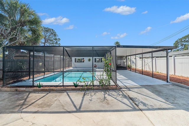 view of swimming pool with a lanai and a patio area