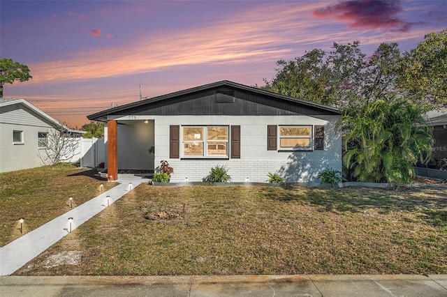 view of front of home with a yard