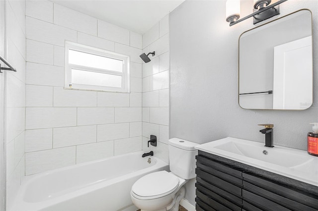 full bathroom with vanity, tiled shower / bath, and toilet