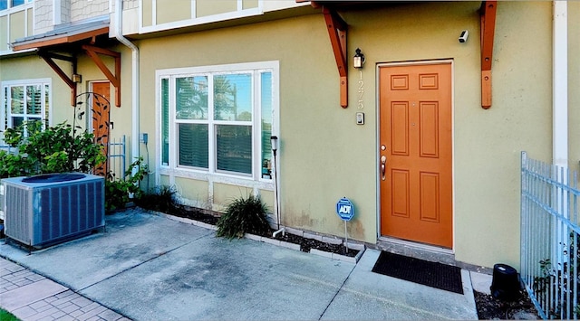 entrance to property with a patio and cooling unit