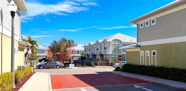 view of road with sidewalks, street lighting, and a residential view