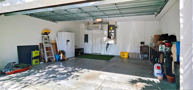 garage with electric panel, heating unit, white refrigerator with ice dispenser, and a garage door opener