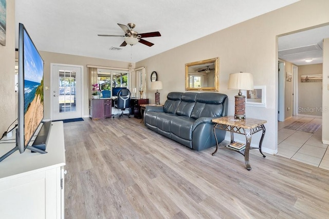 living room featuring light hardwood / wood-style flooring and ceiling fan