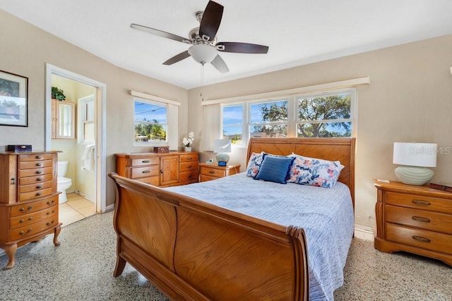 bedroom with ensuite bath and ceiling fan