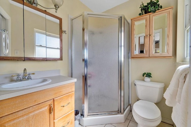 bathroom with vanity, a shower with shower door, tile patterned floors, and toilet