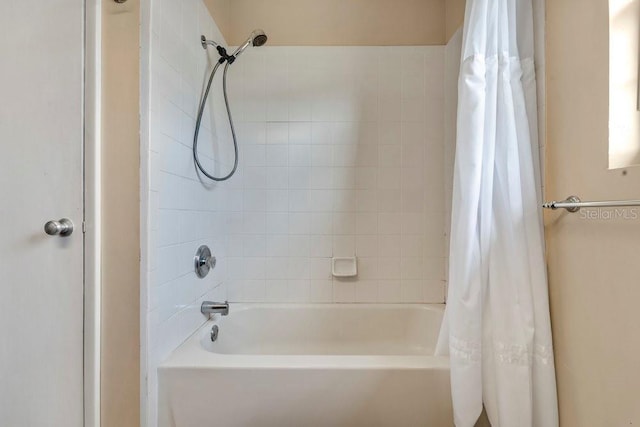 bathroom with shower / tub combo with curtain