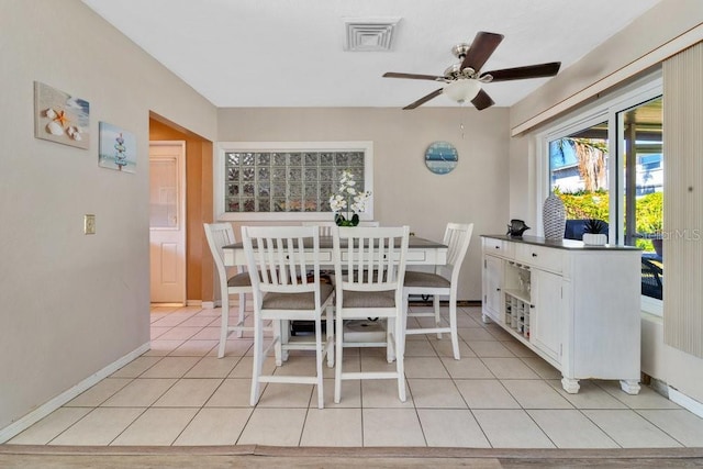 tiled dining area with ceiling fan