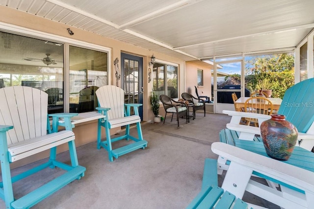 sunroom / solarium with a healthy amount of sunlight and ceiling fan