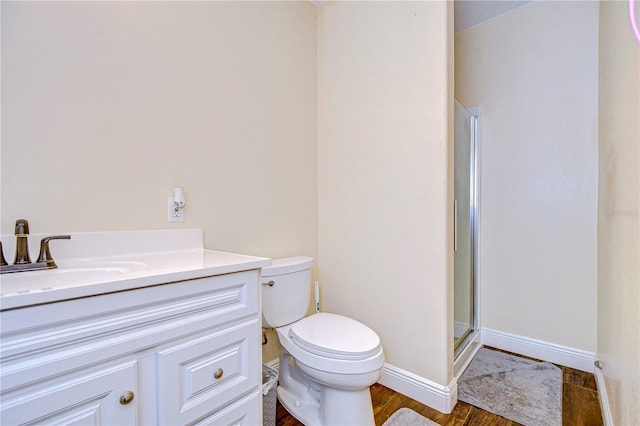 bathroom featuring hardwood / wood-style flooring, vanity, toilet, and an enclosed shower