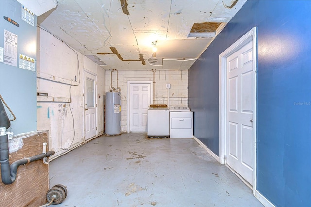 basement featuring electric water heater and washing machine and dryer