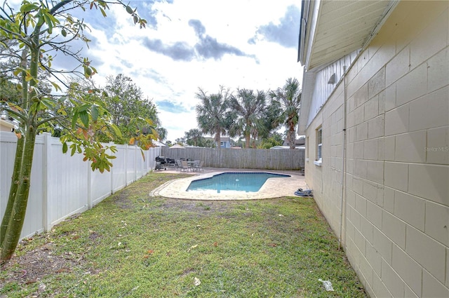 view of pool featuring a yard and a patio area