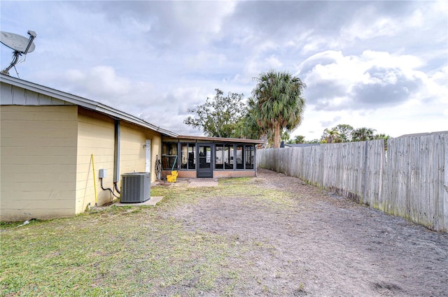 view of yard featuring cooling unit and a sunroom