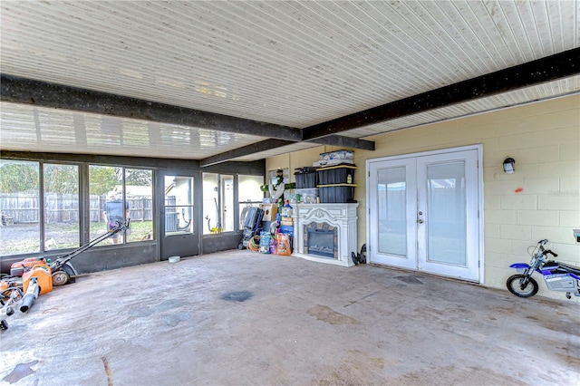 unfurnished sunroom with french doors and beamed ceiling