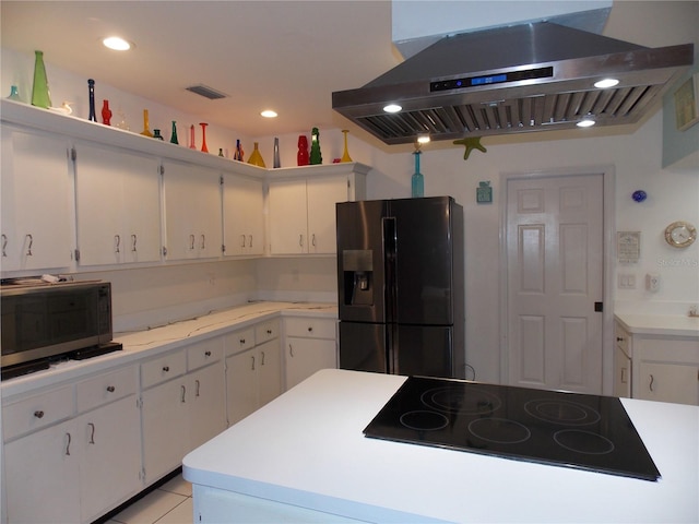 kitchen featuring appliances with stainless steel finishes, exhaust hood, and white cabinets