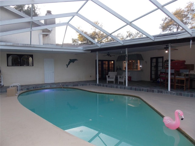 view of pool with ceiling fan, a lanai, and a patio area