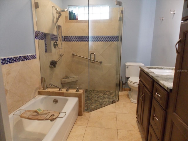 full bathroom featuring tile patterned floors, vanity, toilet, and shower with separate bathtub