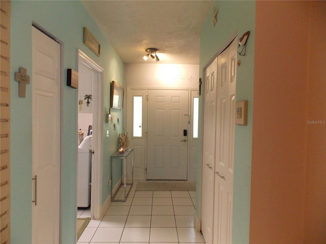 interior space featuring light tile patterned floors and washer / dryer
