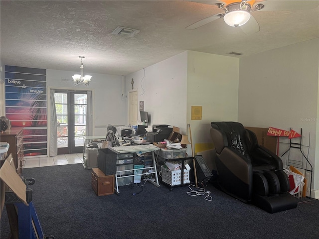 carpeted home office with ceiling fan with notable chandelier, french doors, visible vents, and a textured ceiling