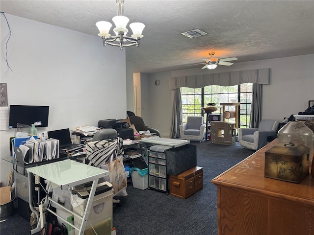 carpeted home office featuring ceiling fan with notable chandelier, visible vents, and a textured ceiling