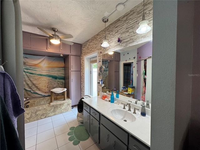 bathroom with tile patterned floors, a ceiling fan, vanity, and a textured ceiling