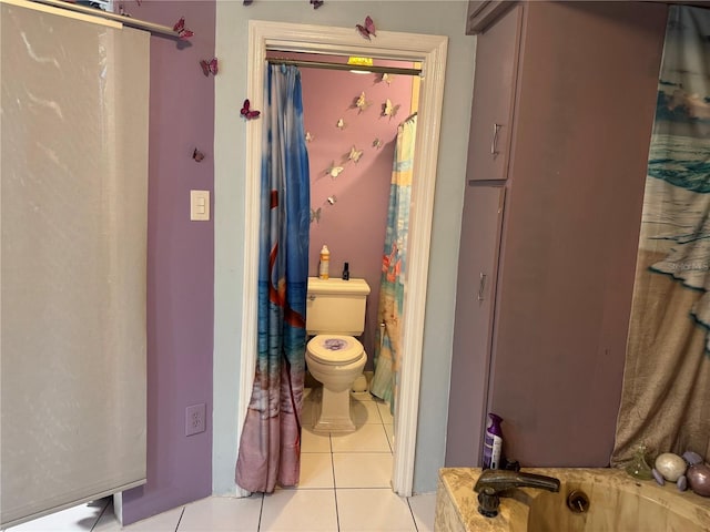 bathroom with tile patterned floors, a sink, and toilet