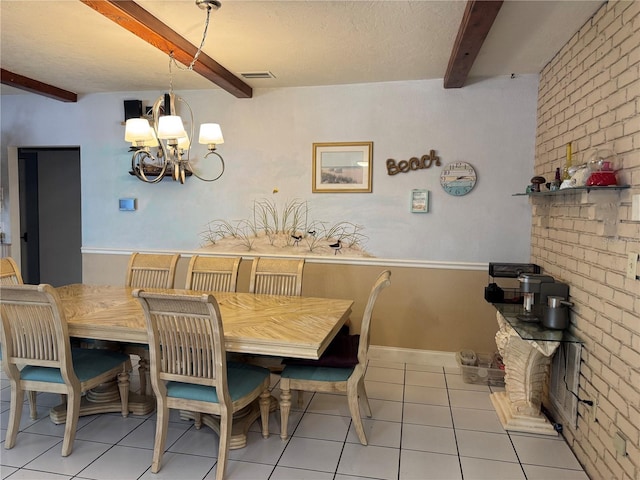 dining space featuring light tile patterned flooring, a chandelier, brick wall, beamed ceiling, and visible vents