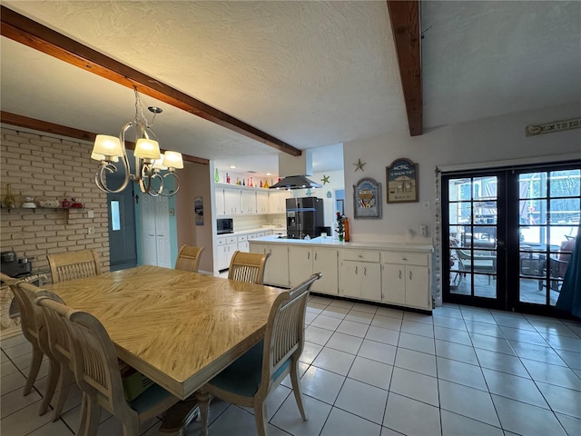 dining space featuring an inviting chandelier, light tile patterned flooring, a textured ceiling, and beamed ceiling