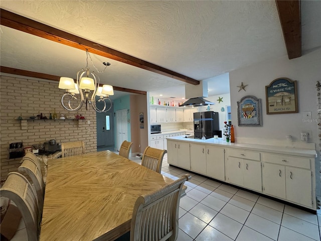 dining room with a notable chandelier, beam ceiling, a textured ceiling, and light tile patterned floors