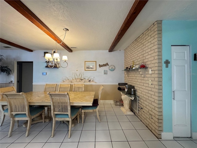 dining area with an inviting chandelier, visible vents, beamed ceiling, and light tile patterned floors