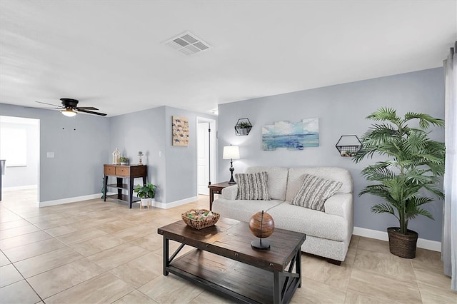 tiled living room with ceiling fan