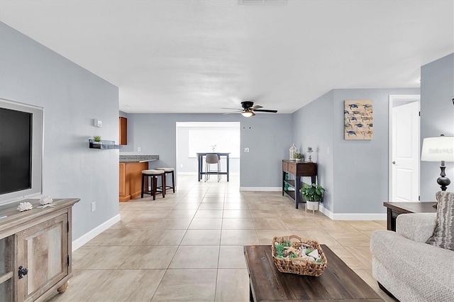 living room with light tile patterned floors and ceiling fan