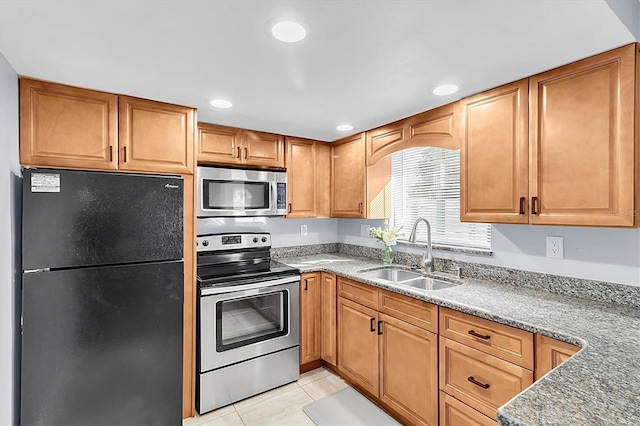 kitchen with stainless steel appliances, sink, and light tile patterned floors