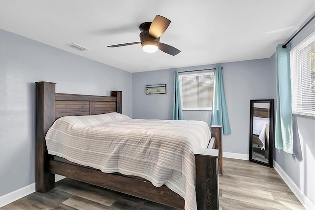 bedroom with ceiling fan and light wood-type flooring