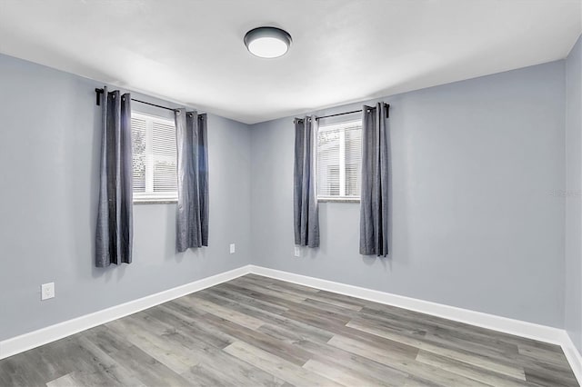 unfurnished room with a healthy amount of sunlight and light wood-type flooring