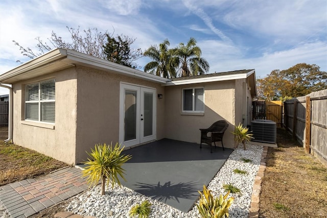 rear view of house featuring a patio, central AC unit, and french doors