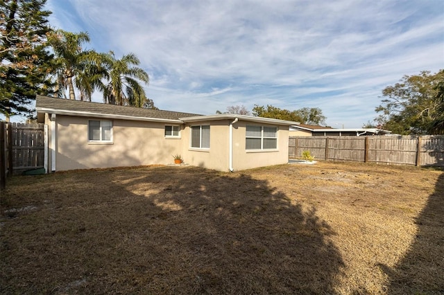 back of house with a yard