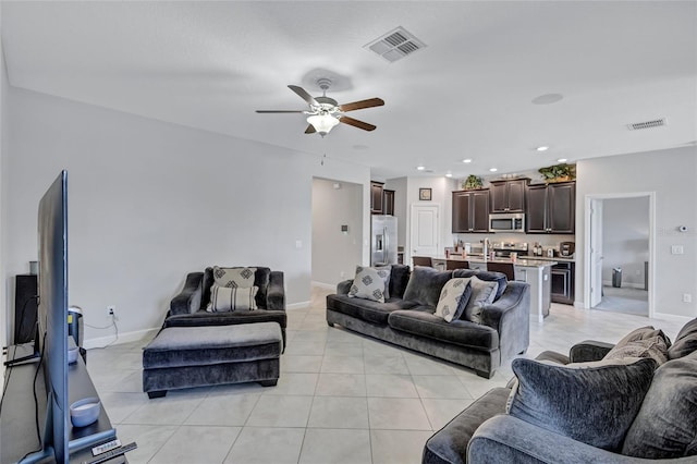 tiled living room with ceiling fan