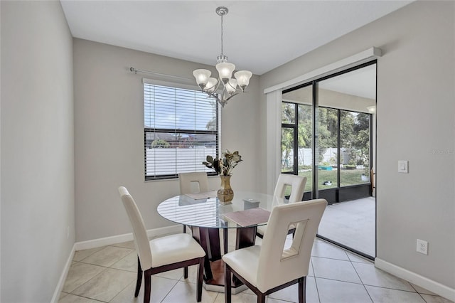 tiled dining space featuring plenty of natural light and a chandelier