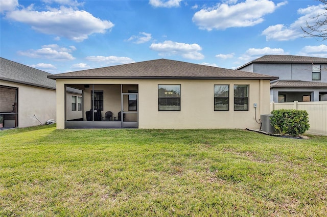 back of house with a sunroom, a yard, and central air condition unit