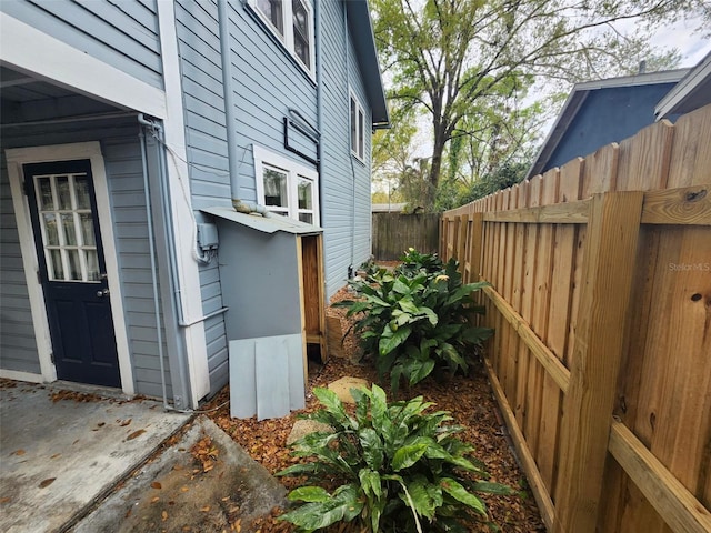 view of side of property featuring fence