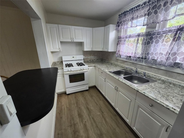 kitchen featuring a sink, white gas range, dark wood-style flooring, and white cabinetry