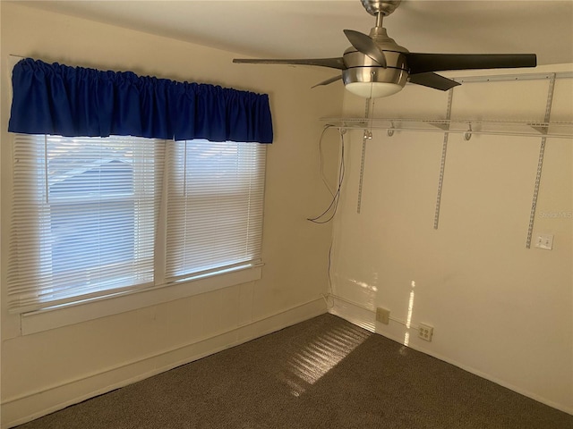 spare room with carpet and a ceiling fan