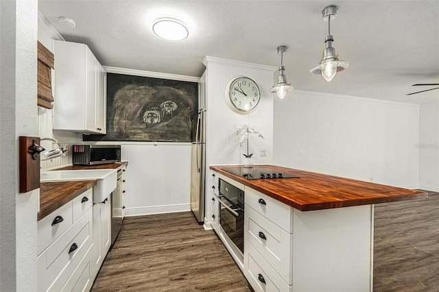 kitchen with butcher block counters, white cabinets, dark hardwood / wood-style flooring, hanging light fixtures, and black appliances