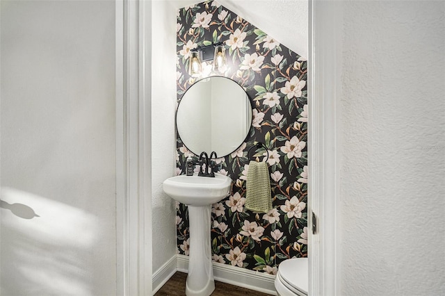 bathroom featuring hardwood / wood-style floors and toilet