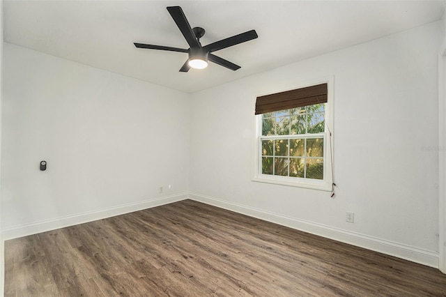 spare room featuring dark hardwood / wood-style floors and ceiling fan